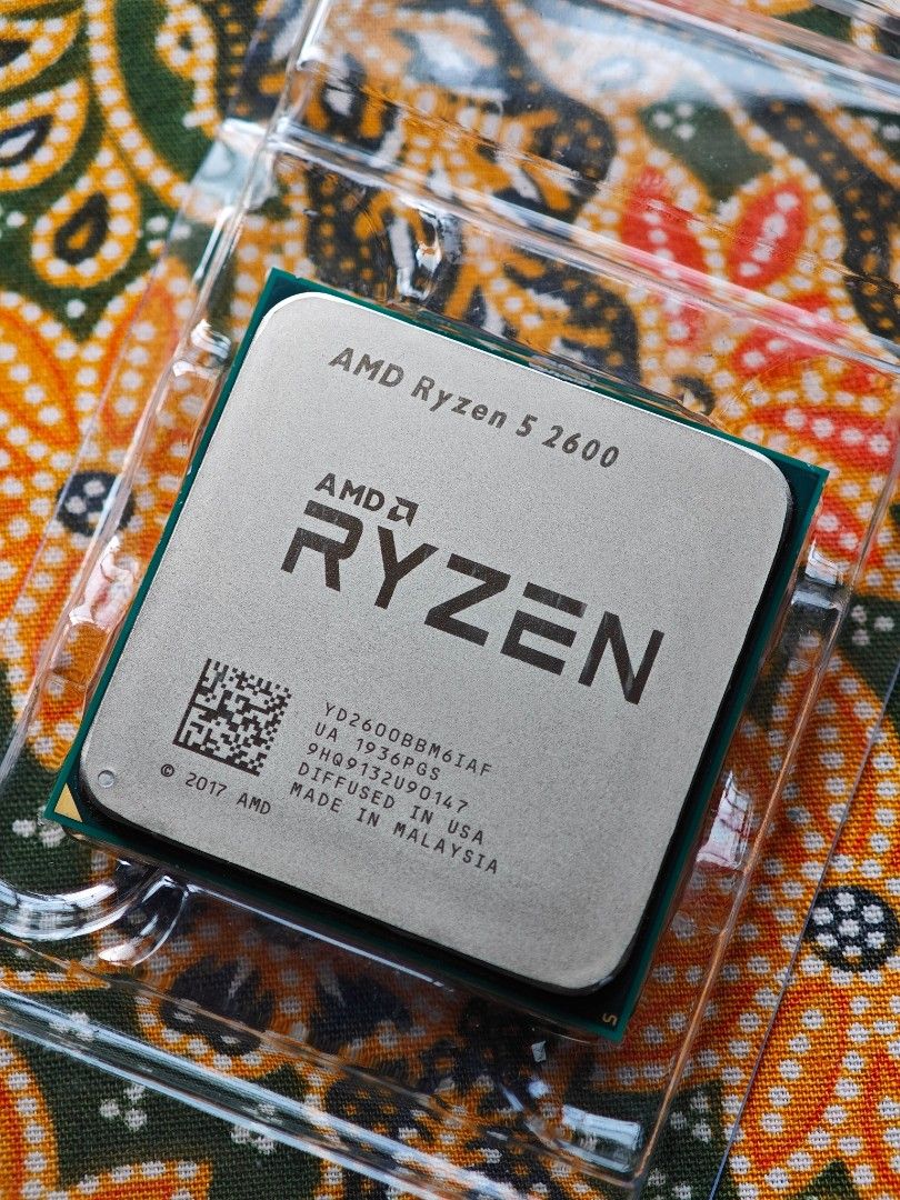 AMD Ryzen 5 2600 Processor (Category: Computer Parts) located in Ampang. Submitted by leeaz97 (Listing ID 1465199021, Image 1). Description: - Model: AMD Ryzen 5 2600 Processor - Specs: 6 Cores, 12 Threads, AM4 Socket - Condition: 100% working pull, runs cool and stable, pins are straight and clean with zero bends - Inclusions: Original clear plastic clamshell container and black cardboard outer sleeve - Perfect budget-friendly upgrade for your g
