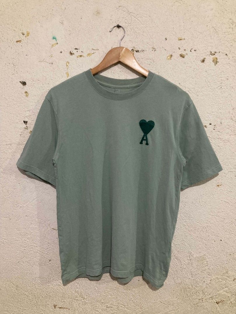 Ami Paris Green Heart Logo Tee (Category: Tshirts & Polo Shirts ) located in San Jose del Monte. Submitted by zen31 (Listing ID 1465270435, Image 1). Description: AMI EMBROIDED LOGO TEE 18.5X25 DIMENSION VERY GOOD CONDITION 9.5/10 COLOR RATE ISSUE: CUT TAGS & STAIN.