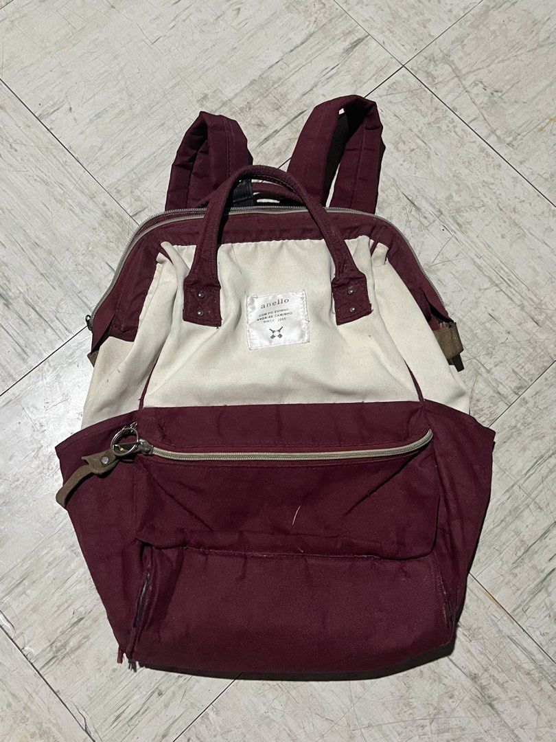 Anello two-tone canvas backpack maroon and cream (Category: Backpacks) located in Makati City. Submitted by byamary (Listing ID 1465314281, Image 1). Description: Maroon and cream Anello backpack. Sturdy canvas material with structured frame opening at the top. Front zipper pocket and side pockets included. Adjustable shoulder straps and grab handles on top..