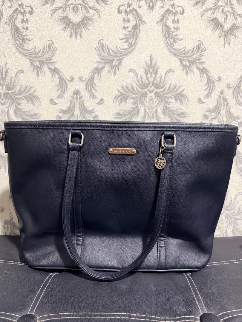 Anne Klein Black Tote Bag (Category: Tote Bags) located in Makati City. Submitted by luckyfire27 (Listing ID 1465183614, Image 1). Description: - Brand: Anne Klein - Material: Premium black faux leather with clean stitching details - Hardware: front logo plaque, and hanging medallion charm - Design: Structured silhouette with comfortable twin shoulder straps - Storage: Spacious interior compartment for daily essentials - Best For: Work, school, d
