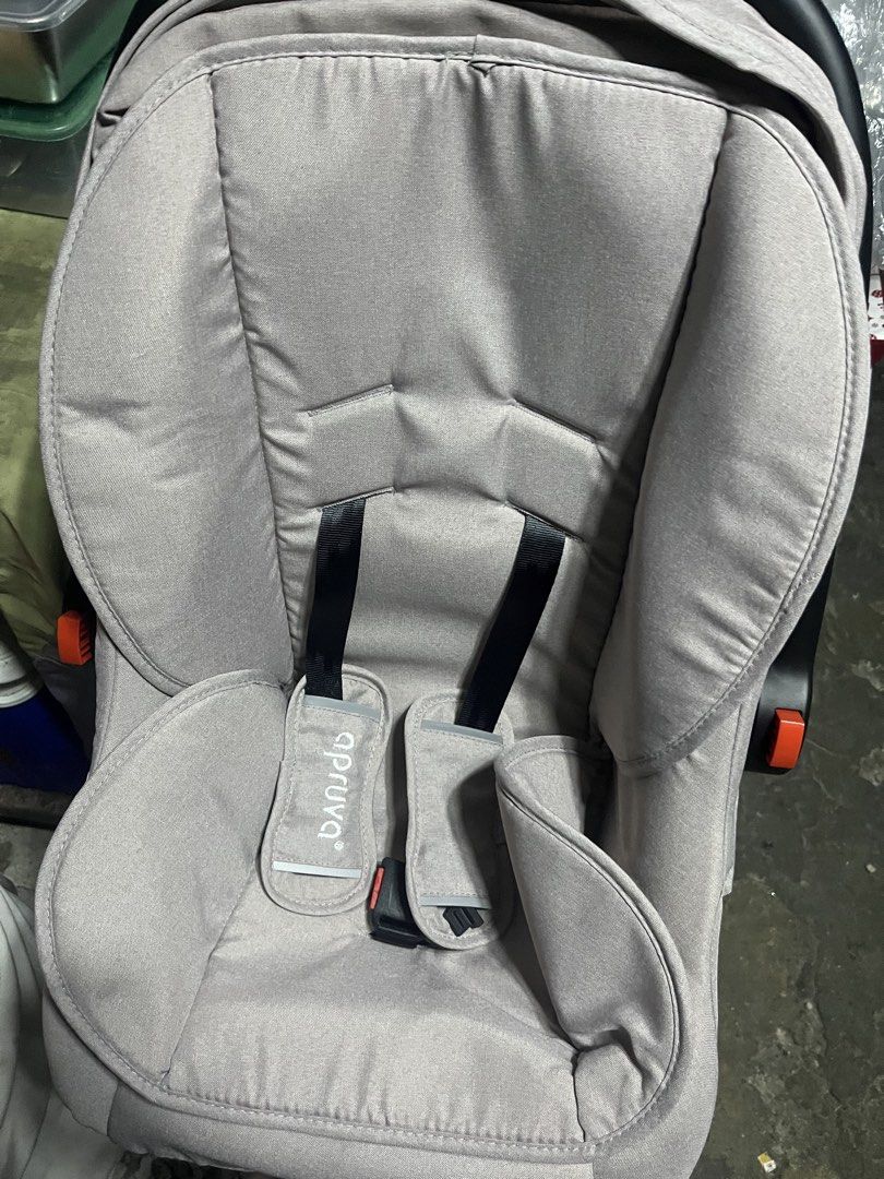 Apruva Infant Car Seat Grey (Category: Car Seats) located in Manila. Submitted by silentwater_f64808 (Listing ID 1465192368, Image 2). Description: Apruva baby car seat in grey. Model SB-209. Rear facing infant carrier style with sturdy black plastic base and adjustable carry handle. Built-in harness straps with shoulder pads included. Label on the back shows manufacture date 11/2023. Clean fabric padding inside, ready for newborn safety travel..