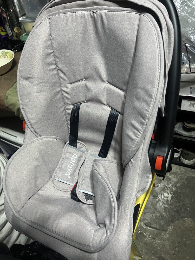 Apruva Infant Car Seat Grey (Category: Car Seats) located in Manila. Submitted by silentwater_f64808 (Listing ID 1465192368, Image 1). Description: Apruva baby car seat in grey. Model SB-209. Rear facing infant carrier style with sturdy black plastic base and adjustable carry handle. Built-in harness straps with shoulder pads included. Label on the back shows manufacture date 11/2023. Clean fabric padding inside, ready for newborn safety travel..