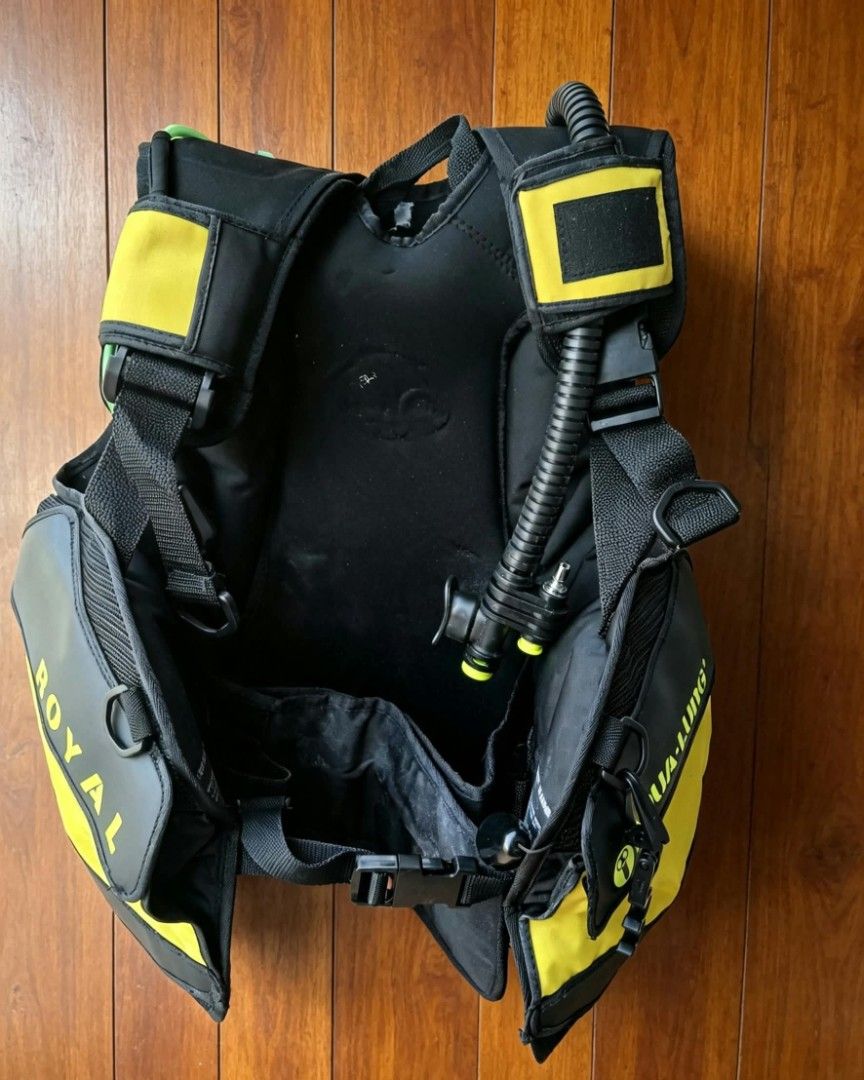 Aqua Lung Royal Scuba Diving BCD Buoyancy Compensator Jacket (Category: Water Sports) located in Naga. Submitted by solamia (Listing ID 1465178843, Image 3). Description: - Brand: Aqua Lung Royal - Type: Scuba diving buoyancy compensator (BC) jacket - Color: Black and yellow design - Features: Integrated inflator hose and multiple dump valves - Fit: Fully adjustable straps and secure waist belt - Build: Sturdy plastic backplate for stability - Co