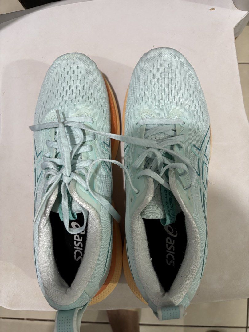 Asics Glideride Max Light Teal Running Shoes Size US 10 (Category: Casual Shoes) located in Manila. Submitted by jonard2297 (Listing ID 1465274946, Image 2). Description: - Brand/Model: Asics Glideride Max - Colorway: Light Teal, Orange, and Yellow - Size: US 10 / EU 42 / CM 26.5 - Condition: Lightly tested, outsoles show minor dirt - Defect: Small fabric tear near the left heel pull tab (see last photo) - Performance: Cushioning and grip still h