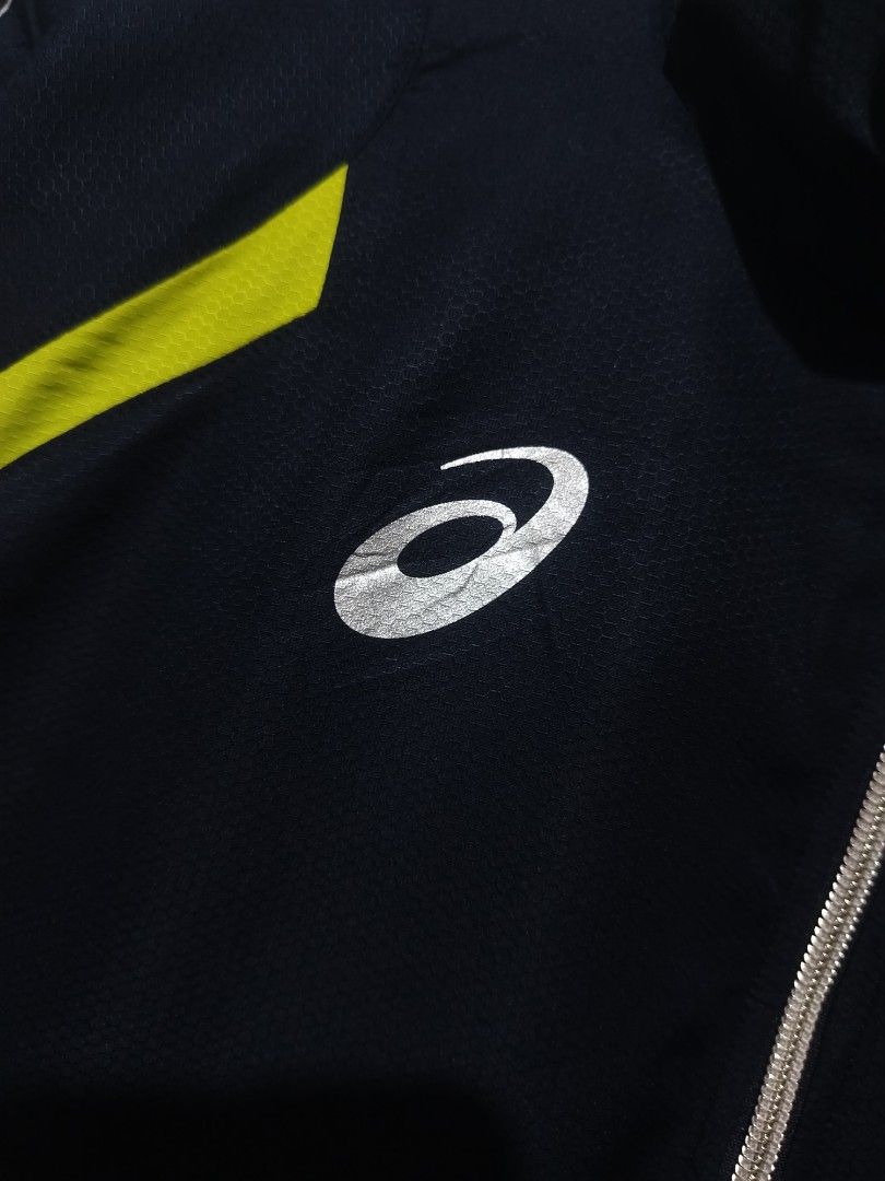 Asics Motiontherm Windbreaker Jacket (Category: Coats, Jackets and Outerwear) located in Rizal. Submitted by gmpastoffi75031 (Listing ID 1465322989, Image 2). Description: - Brand: Asics - dimes 23x27.5 - Color: Black with lime green and silver reflective accents - Features: Full zip closure, high collar, elastic cuffs, and Motiontherm tech print - Fabric: Lightweight with subtle honeycomb texture - Best for: Running, training, and casual sportsw