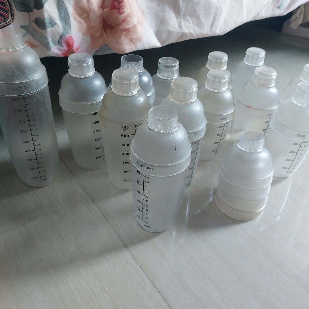 Assorted Plastic Shaker Bottles Take All (Category: Water Bottles & Tumblers) located in Taguig. Submitted by i_am_blessygrei (Listing ID 1465231260, Image 2). Description: - Bulk lot of translucent plastic shaker bottles in various sizes (500cc, 700cc, and a tall 1000cc) SHAKER 1 1L, 5PCS 700ML, 7PCS 500ML - Features clear measurement markings in CC and ML - Includes secure screw-on caps and built-in strainer lids - Great for protein shakes, fit