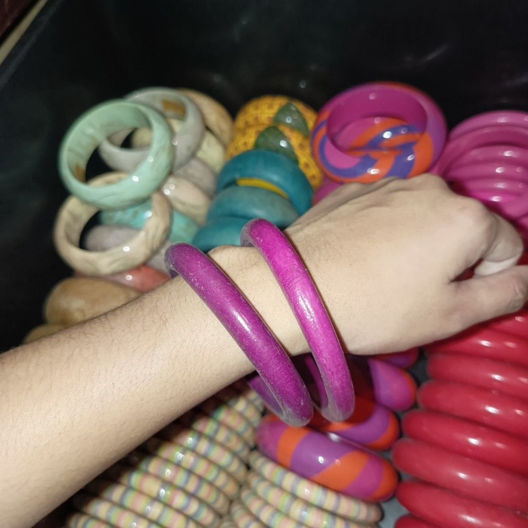 Assorted Wooden and Resin Bangles Lot (Category: Bracelets) located in Bulacan. Submitted by snumxxx (Listing ID 1465276937, Image 3). Description: - Assorted colorful bangles in a box - Styles include wooden segmented, bright pink, purple, and multi-colored stripes - Great stackable accessories for everyday outfits - Available individually.