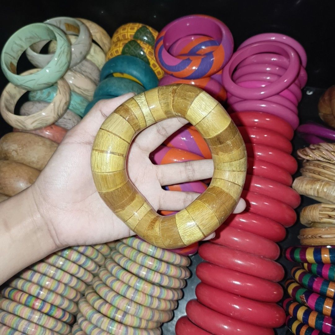 Assorted Wooden and Resin Bangles Lot (Category: Bracelets) located in Bulacan. Submitted by snumxxx (Listing ID 1465276937, Image 2). Description: - Assorted colorful bangles in a box - Styles include wooden segmented, bright pink, purple, and multi-colored stripes - Great stackable accessories for everyday outfits - Available individually.