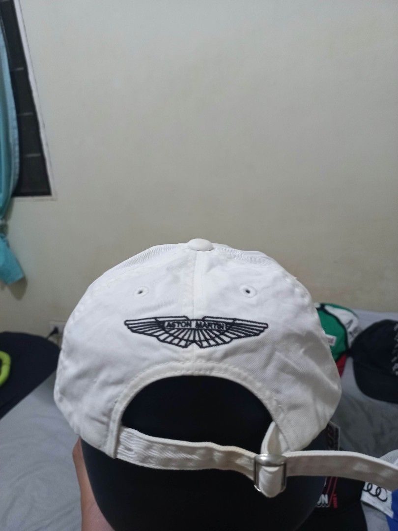 Aston Martin S White Baseball Cap (Category: Caps & Hats) located in Davao. Submitted by thegraildept2026 (Listing ID 1465178707, Image 2). Description: - Authentic white Aston Martin baseball cap - Detailed embroidered logo on front and back with the letter S - Adjustable strap with a metal buckle for a custom fit - Features interior tag stitched inside - Condition: Minor signs of wear and slight discoloration around the brim.