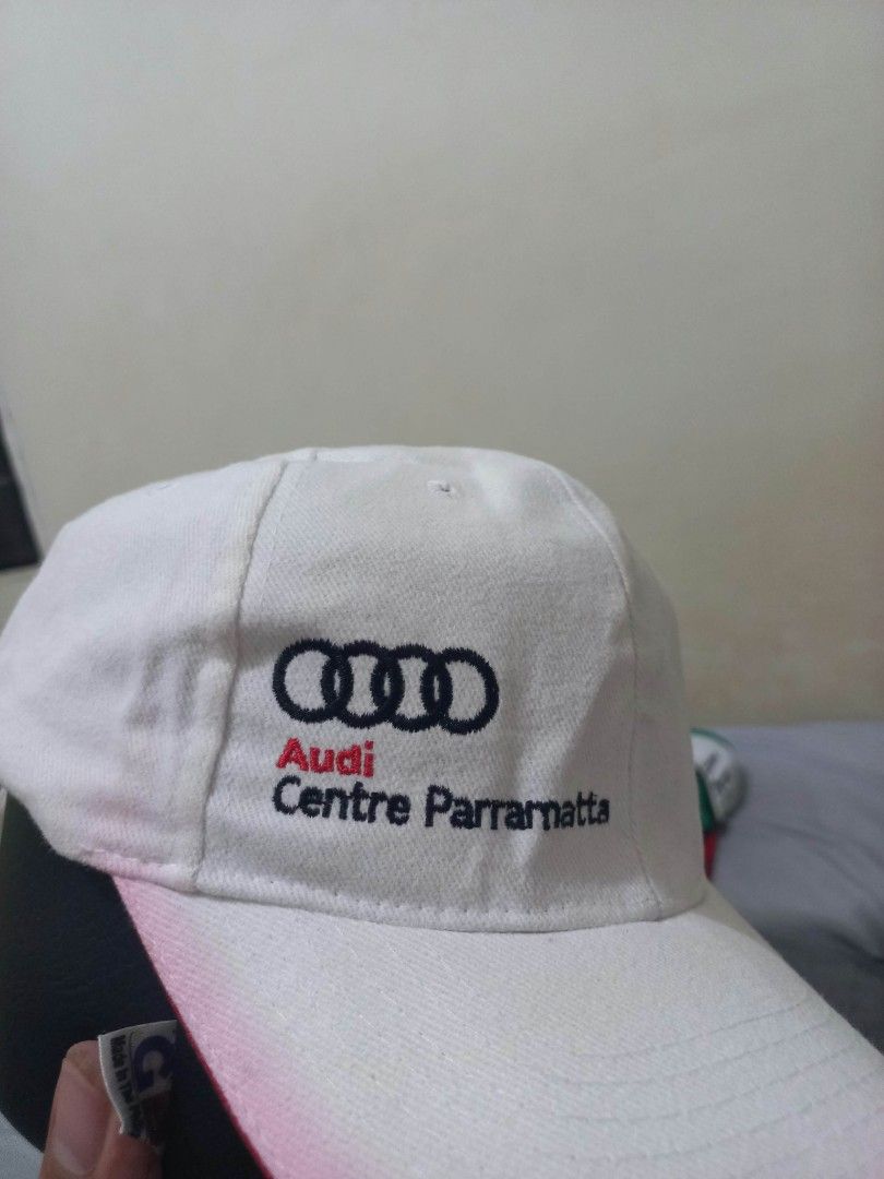 Audi Centre Parramatta White Cap Hat (Category: Caps & Hats) located in Davao. Submitted by thegraildept2026 (Listing ID 1465178705, Image 2). Description: - Authentic Audi Centre Parramatta merchandise - Classic white baseball cap with adjustable strapback closure - Features the iconic black four rings logo and red/black lettering - Styled with a curved brim and striking red piping trim - Perfect condition and ready to wear.