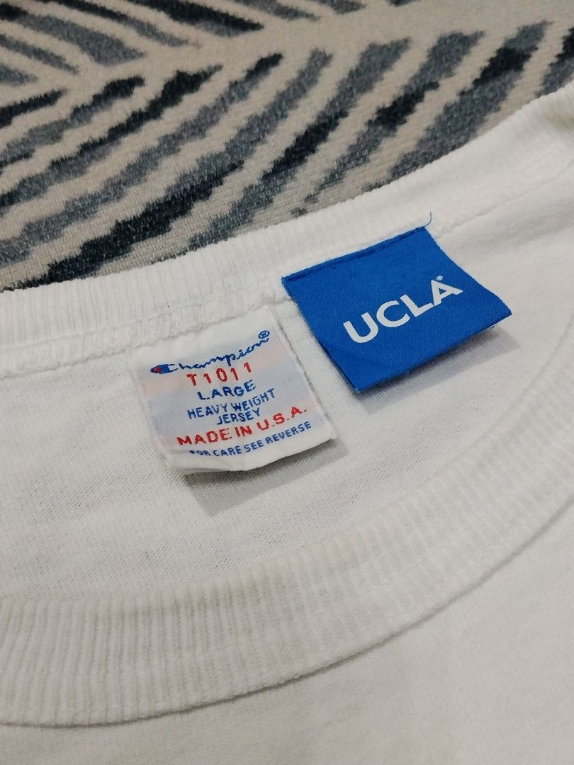 Authentic Champion T1011 UCLA Heavyweight Jersey (Category: Tshirts & Polo Shirts ) located in Manila. Submitted by titokingcuratedarchive (Listing ID 1465203280, Image 3). Description: - Brand/Model: Champion T1011 UCLA Heavyweight Jersey T-Shirt - Color: White with classic blue UCLA collegiate front graphic - Size: Large - Origin: Made in USA - Material: Premium thick cotton fabric for maximum durability - Details: Iconic Champion C-logo patch 