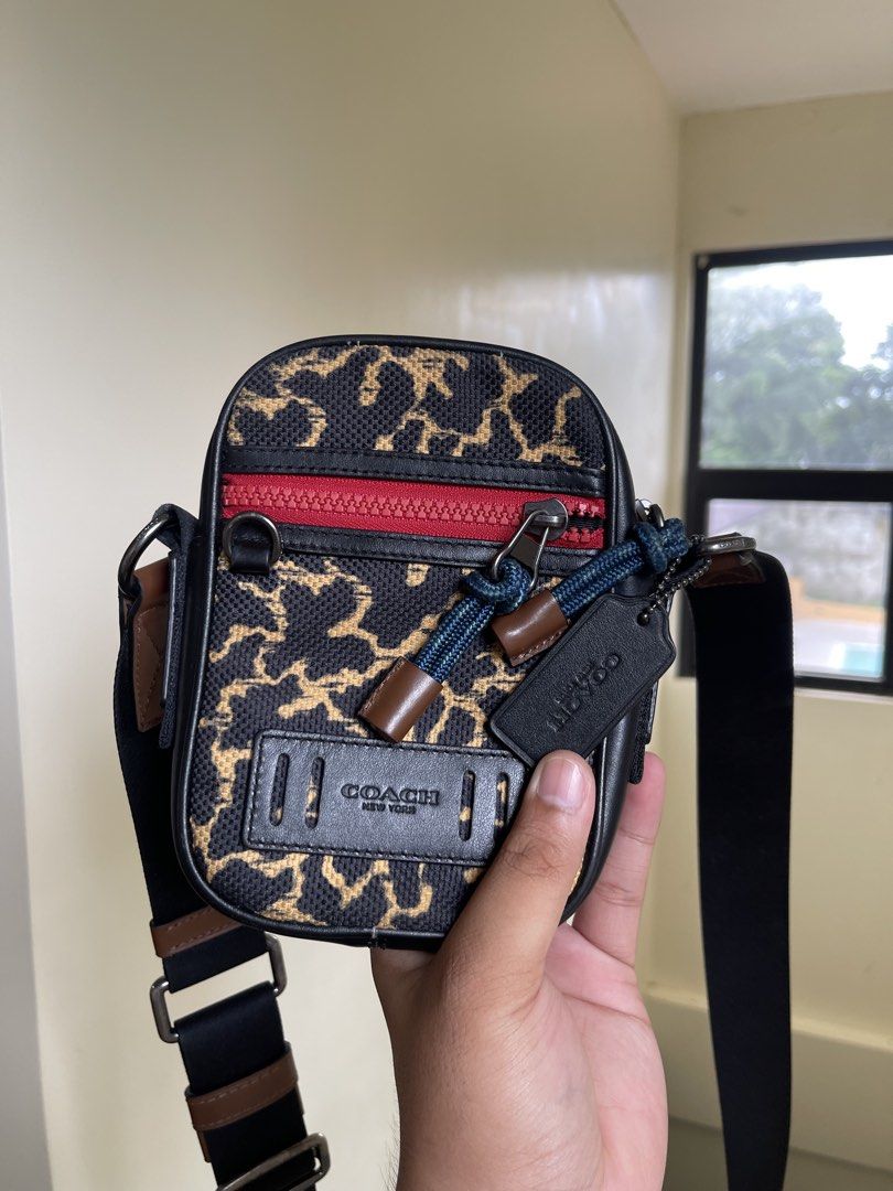 Authentic Coach Leopard Print Crossbody Bag (Category: Sling Bags) located in Manila. Submitted by timmyyyyyy69 (Listing ID 1465274687, Image 2). Description: - Brand: Coach - Design: Leopard print canvas with black leather trim and bright red front zipper - Features: Adjustable black strap with leather accents, dark fabric lining, and official Coach leather creed patch inside - Size: Compact and lightweight, ideal for daily essentials - Style: H
