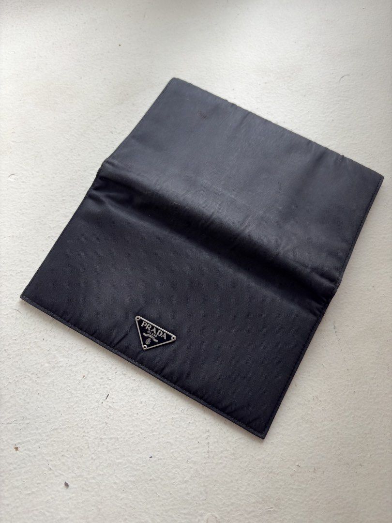Authentic Prada Tessuto Nylon Continental Flap Long Wallet (Category: Luxury Bags & Wallets) located in Mandaluyong City. Submitted by wear_your_style (Listing ID 1465198556, Image 2). Description: Super steal. Bought this preloved in Japan years ago. Made in Italy. Combination of nylon (outer) and saffiano leather (inner) materials. Snap button closure, snappy pa yan. Well structured pa yan. Black pa. Prada triangle logo wala namang scratches. M