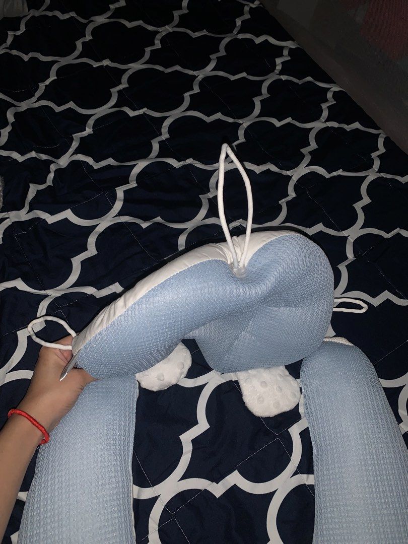 Baby Head Shaping Pillow Anti-Flat Blue (Category: Children's Beds) located in Manila. Submitted by annikka.cloud (Listing ID 1465349321, Image 2). Description: - Blue baby shaping pillow with adjustable side support rolls - Breathable textured fabric for baby's comfort - Cute white plush paw details on the headrest - Convenient loops for hanging or securing - Strap with snap-button closure to keep lower support arms in place - Clean, sanitized, 