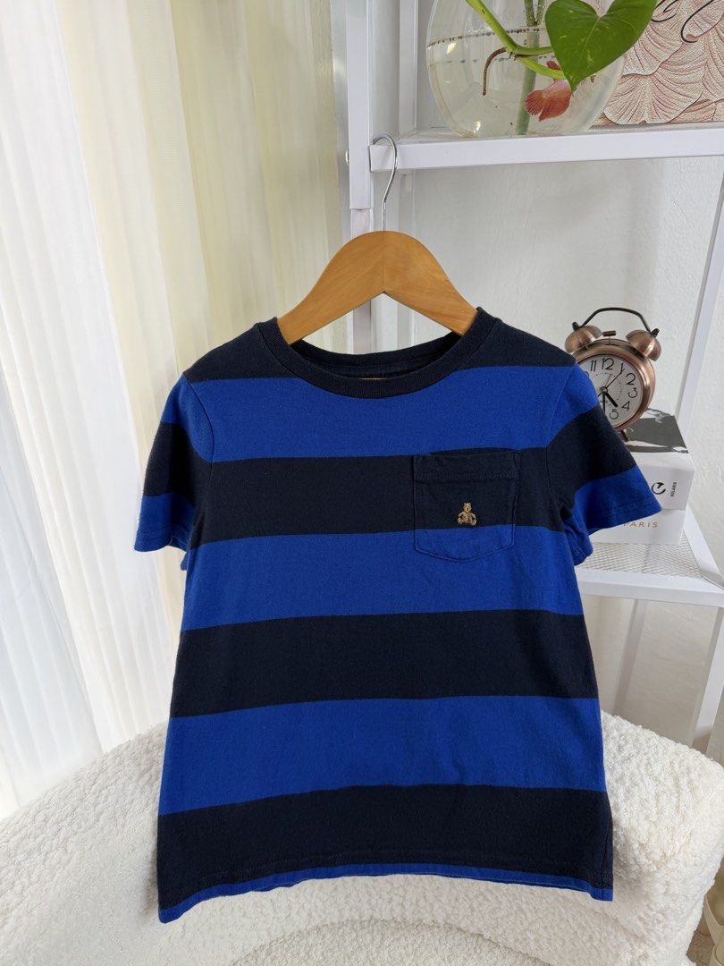 BabyGap Blue Black Striped Bear Tee Size 2T (Category: Babies & Kids Fashion) located in Manila. Submitted by happy_kidsapparel (Listing ID 1465248636, Image 1). Description: BabyGap toddler t-shirt in blue and black stripes. Short sleeves, crew neck, and one chest pocket. Little embroidered bear icon on the pocket. Size 2T on the inner label. 100 percent cotton material. Clean and well maintained..
