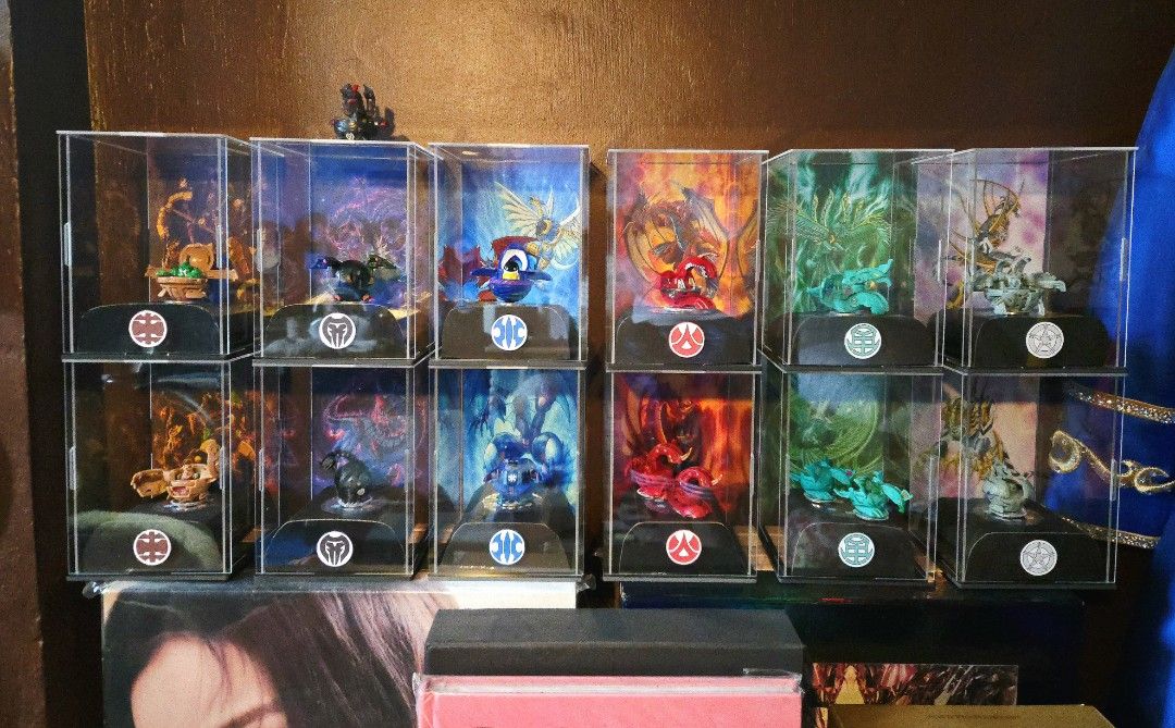 Bakugan Collection with Display Cases All Six Attributes (Category: Action & Battle Toys) located in Rizal. Submitted by silo2191 (Listing ID 1465358363, Image 1). Description: - Complete full set of Bakugan figures across all 6 factions: Subterra, Darkus, Haos, Pyrus, Ventus, and Aquos - Displayed in clear acrylic cases featuring custom art backdrops - Kept clean and well-maintained on shelf display - Ideal and ready-made setup for serious colle