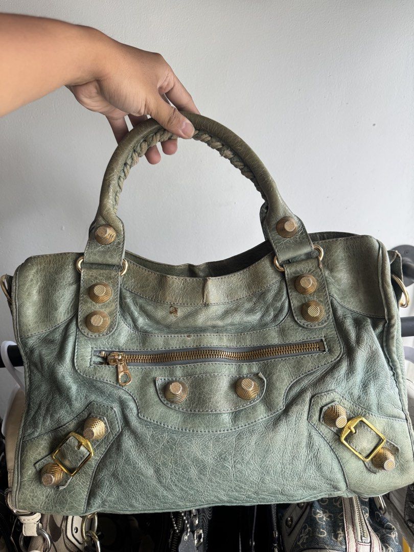 Balenciaga city bag (Category: Luxury Bags & Wallets) located in Quezon City. Submitted by streetgallerygarments (Listing ID 1465199754, Image 1). Description: Balenciaga Giant City Bag in a muted green leather, beautifully detailed with signature gold-tone giant hardware and hand-stitched braided handles..