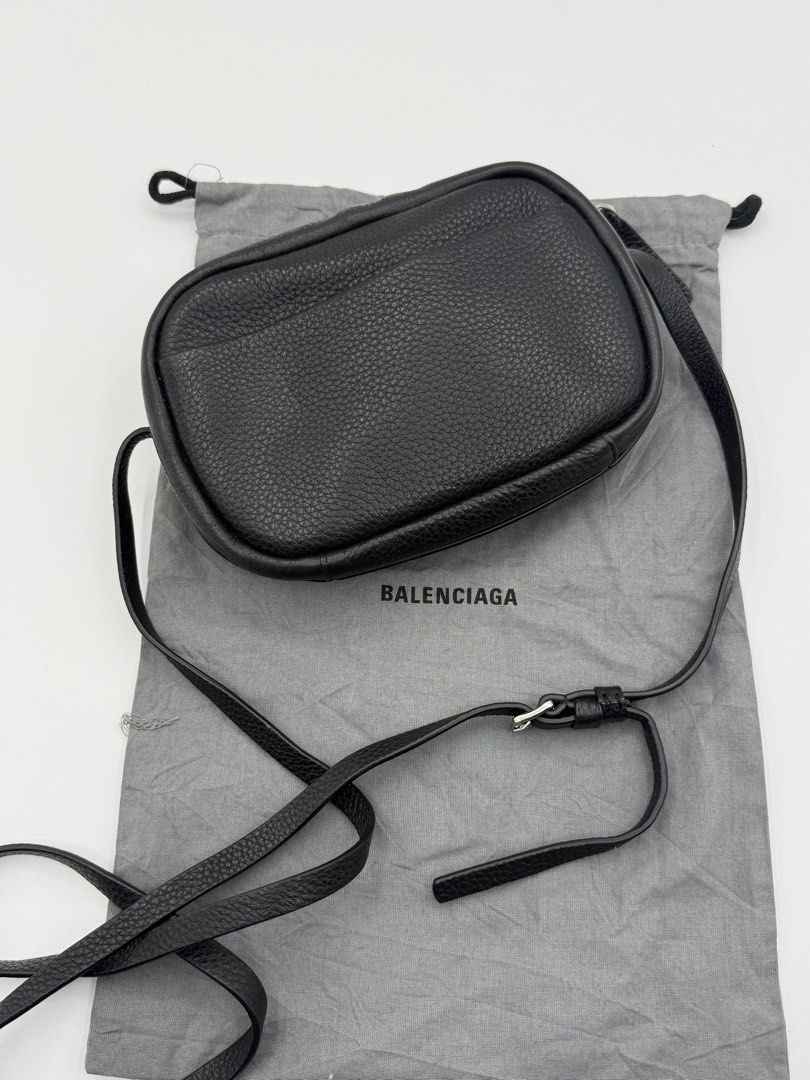 Balenciaga Everyday Camera Bag Black (Category: Cross-body Bags) located in Caloocan City. Submitted by rossvault2 (Listing ID 1465235636, Image 2). Description: - Balenciaga crossbody bag - Black textured leather with white front logo - Adjustable thin shoulder strap with silver-tone hardware - Secure top zip closure - Clean interior featuring a small slip pocket and card slots - Includes original grey Balenciaga dust bag - Condition: Excellent/
