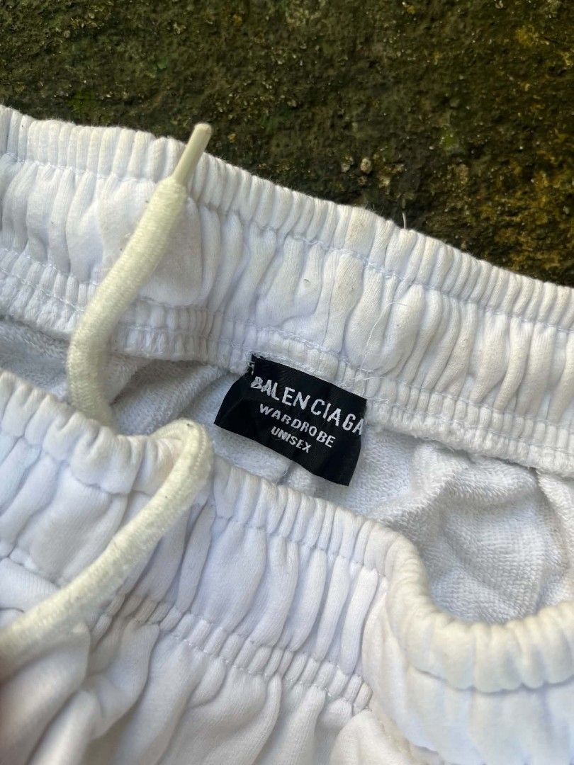 Balenciaga Wardrobe Multi-Logo Sweatpants White Size L (Category: Joggers) located in Manila. Submitted by sls.wear (Listing ID 1465207376, Image 2). Description: - Brand: Balenciaga - Model: Wardrobe Sweatpants - Color: White - Size: Large (L) - Design: All-over sponsor-style logo graphics on both legs - Material: Thick cotton loopback fleece - Fit: Straight leg, relaxed streetwear style - Features: Elastic waistband with adjustable drawstring -