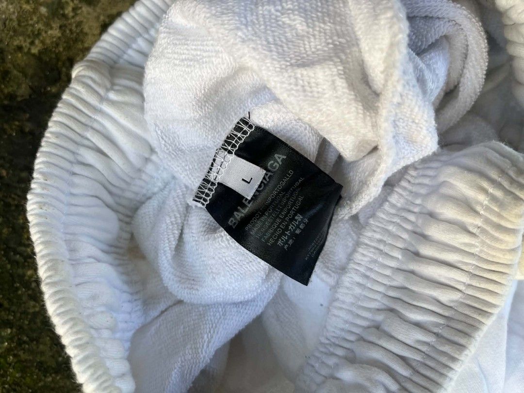 Balenciaga Wardrobe Multi-Logo Sweatpants White Size L (Category: Joggers) located in Manila. Submitted by sls.wear (Listing ID 1465207376, Image 3). Description: - Brand: Balenciaga - Model: Wardrobe Sweatpants - Color: White - Size: Large (L) - Design: All-over sponsor-style logo graphics on both legs - Material: Thick cotton loopback fleece - Fit: Straight leg, relaxed streetwear style - Features: Elastic waistband with adjustable drawstring -