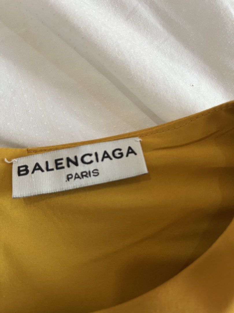 Balenciaga Yellow Blouse (Category: Blouses) located in Muntinlupa City. Submitted by jane226ph (Listing ID 1465204183, Image 3). Description: Brand New •Never used Elegant and timeless piece Sleeves: long with wide, flared bell cuffs Fits : Small to Medium Gifted / Extra Piece No occasion to use, so we’re letting it go. Original purchase details unavailable. Authenticity cannot be independently verified. Sold as-is .