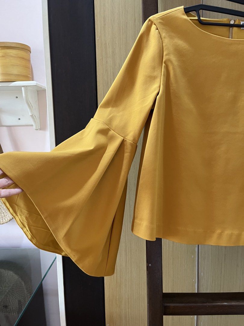 Balenciaga Yellow Blouse (Category: Blouses) located in Muntinlupa City. Submitted by jane226ph (Listing ID 1465204183, Image 2). Description: Brand New •Never used Elegant and timeless piece Sleeves: long with wide, flared bell cuffs Fits : Small to Medium Gifted / Extra Piece No occasion to use, so we’re letting it go. Original purchase details unavailable. Authenticity cannot be independently verified. Sold as-is .