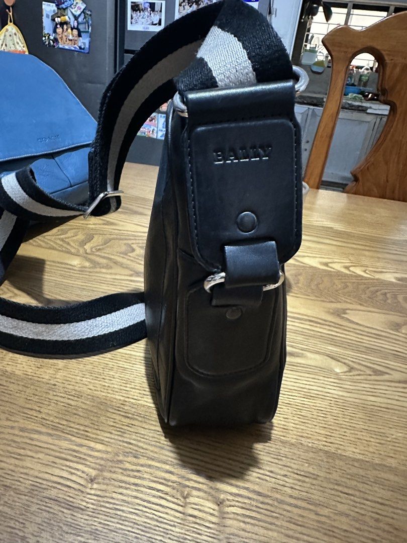 Bally Black Leather Crossbody Bag (Category: Cross-body Bags) located in Quezon City. Submitted by pongoy (Listing ID 1465282987, Image 2). Description: - Brand: Bally - Material: Supple black leather - Design: Structured rectangular shape with contrast stitching and dual metal stud accents - Closure: Secure top zip - Strap: Adjustable black and white striped web strap with silver-toned hardware - Condition: Clean and well-maintained, ideal for e