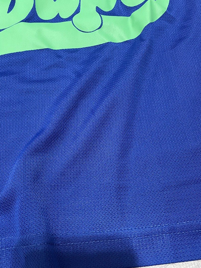Bape Blue Green Script Logo Tank Top (Category: Babies & Kids Fashion) located in Dagupan City. Submitted by fahionista1988 (Listing ID 1465207862, Image 2). Description: - Color: Bright blue with a large green Bape script logo on the chest - Material: Lightweight mesh-style athletic fabric with ribbed collar and arm openings - Condition: Clean, no marks or pulls - Style: Sleeveless tank top, ideal for casual streetwear.