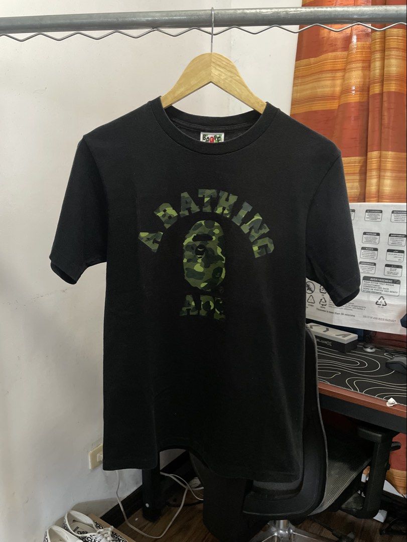 Bape College Tee (Category: Tshirts & Polo Shirts ) located in Manila. Submitted by kabloh (Listing ID 1465285466, Image 1). Description: College Tee Dark Green Camo (Big gold tag) Gently used | Great Condition Small 18x26 No issue Color rate: 8.8-9/10 Authentic Slightly nego .