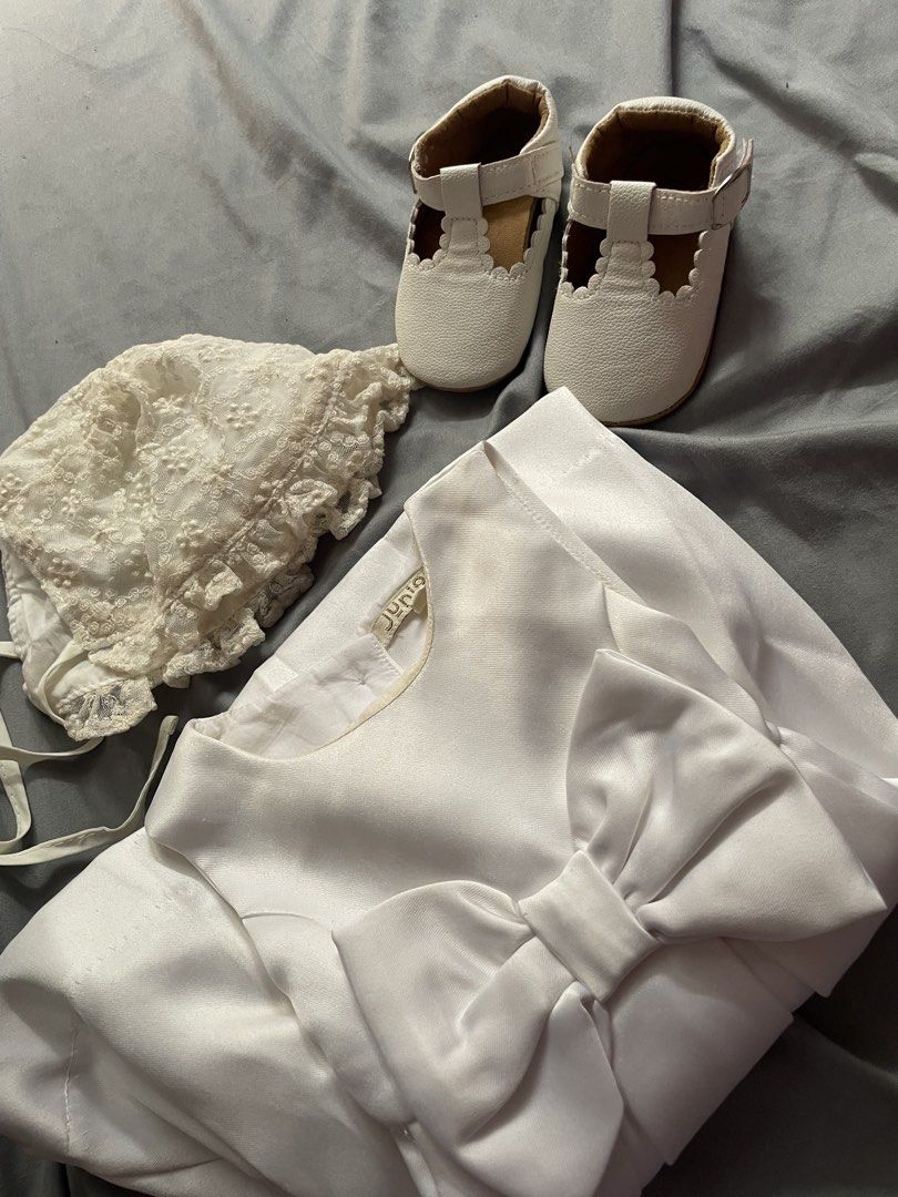 Baptismal dress set (Category: Babies & Kids Fashion) located in Cainta. Submitted by cof.fee (Listing ID 1465176834, Image 1). Description: - Brand: Juniors - Size: 9-12 months (80cm) on tag but runs small, best fit 6 months‼️ - Color: Classic White - Set includes: Sleeveless satin dress with large front bow and back buttons, matching lace bonnet with ties, and white t-strap baby shoes with scalloped edges - Condition: Worn once, super clean and