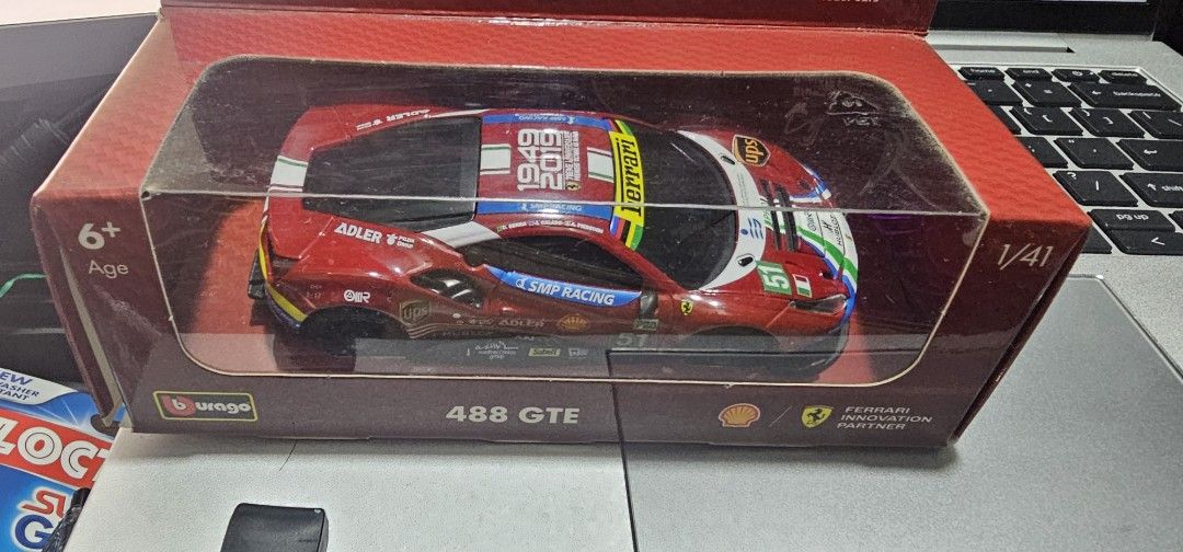Bburago Ferrari 488 GTE Shell Racing Legends 1/41 Scale (Category: Vehicle & Diecast Models) located in Las Pinas. Submitted by xenoraine (Listing ID 1465338329, Image 1). Description: - Brand: Bburago 1/41 scale Ferrari 488 GTE Shell Racing Legends - Features authentic #51 SMP Racing, Adler, UPS, and Shell decals with 1949-2019 anniversary roof graphics - App-compatible Bluetooth remote control functionality - Condition: Slightly used inside ori