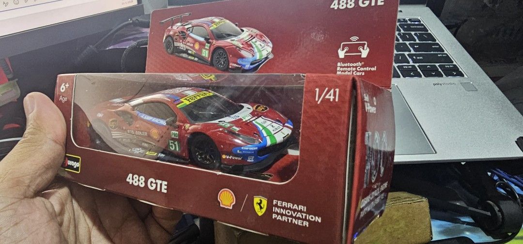 Bburago Ferrari 488 GTE Shell Racing Legends 1/41 Scale (Category: Vehicle & Diecast Models) located in Las Pinas. Submitted by xenoraine (Listing ID 1465338329, Image 3). Description: - Brand: Bburago 1/41 scale Ferrari 488 GTE Shell Racing Legends - Features authentic #51 SMP Racing, Adler, UPS, and Shell decals with 1949-2019 anniversary roof graphics - App-compatible Bluetooth remote control functionality - Condition: Slightly used inside ori
