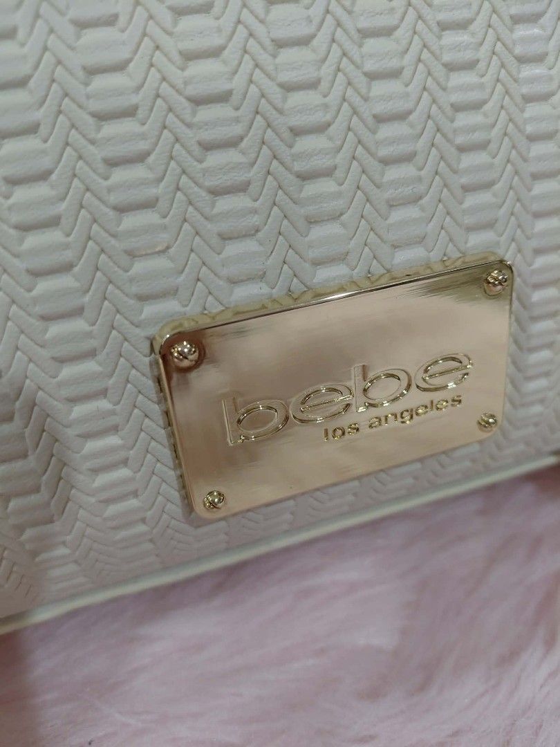 Bebe White Textured Handbag (Category: Tote Bags) located in Pasig City. Submitted by janalopez904 (Listing ID 1460505940, Image 2). Description: - Authentic Bebe textured handbag - Features a prominent gold Bebe logo plate on the front - Comes with original tags still attached - Original retail price: $549 - Selling price: ₱1,500.