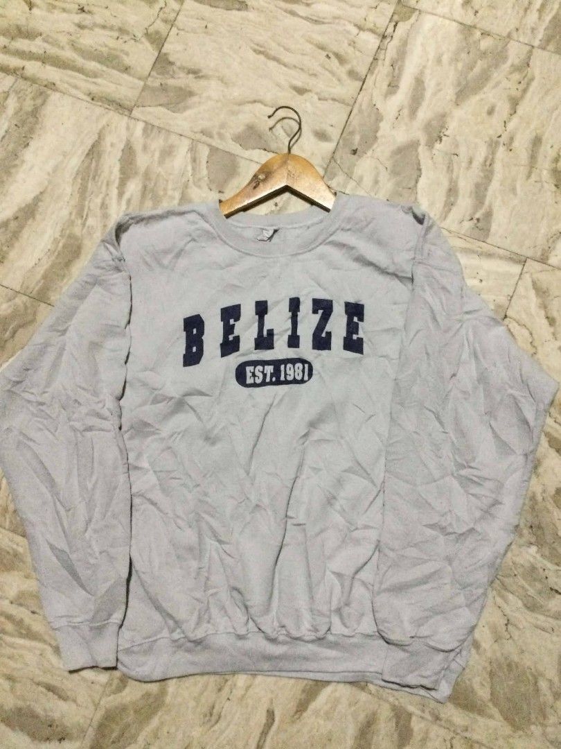 Belize Est. 1981 Grey Sweatshirt (Category: Coats, Jackets and Outerwear) located in Calumpit. Submitted by kylus_asten17 (Listing ID 1465328790, Image 1). Description: - Color: Grey with navy blue 'Belize Est. 1981' chest print - Style: Classic crewneck, long sleeves, ribbed cuffs, pullover - Fit: Comfortable for casual, everyday wear - Condition: Brand new/good, but has storage wrinkles (needs a quick wash or iron before use).