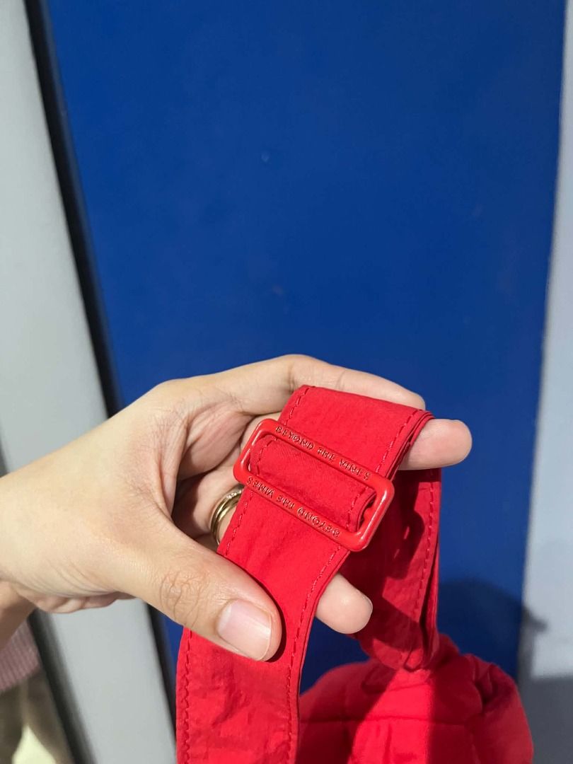 Beyond The Vines Red Puffer Sling Bag (Category: Cross-body Bags) located in Quezon City. Submitted by astargeaaa (Listing ID 1463759194, Image 3). Description: - Brand: Beyond The Vines - Color: Red - Style: Puffer Sling Bag - Material: Soft, lightweight - Features: Adjustable strap, easy to clean - Perfect for: Everyday use, carrying essentials (phone, wallet, keys) - Adds: A pop of color to any outfit.