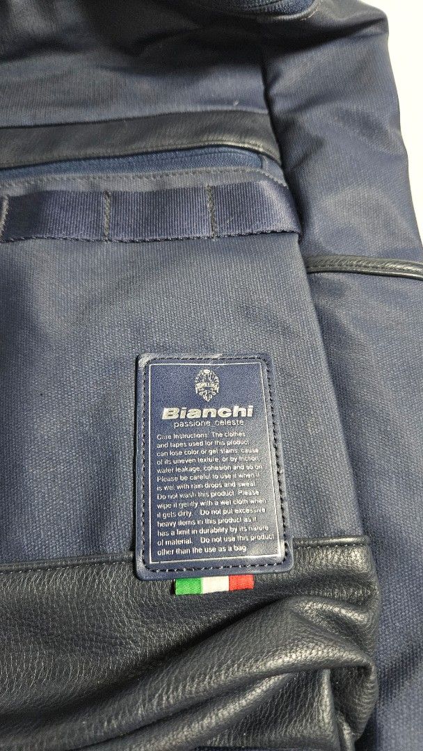 Bianchi Navy Blue Backpack with Celeste Interior (Category: Backpacks) located in Alfonso. Submitted by jbcamet (Listing ID 1465240439, Image 2). Description: - Brand: Bianchi - Color: Navy blue with bright celeste green interior - Material: Durable fabric with faux leather accents - Design: Signature Italian flag detail on the front pocket and outer label - Storage: 1 main compartment, 1 interior zippered pocket, and multiple slip compartments -