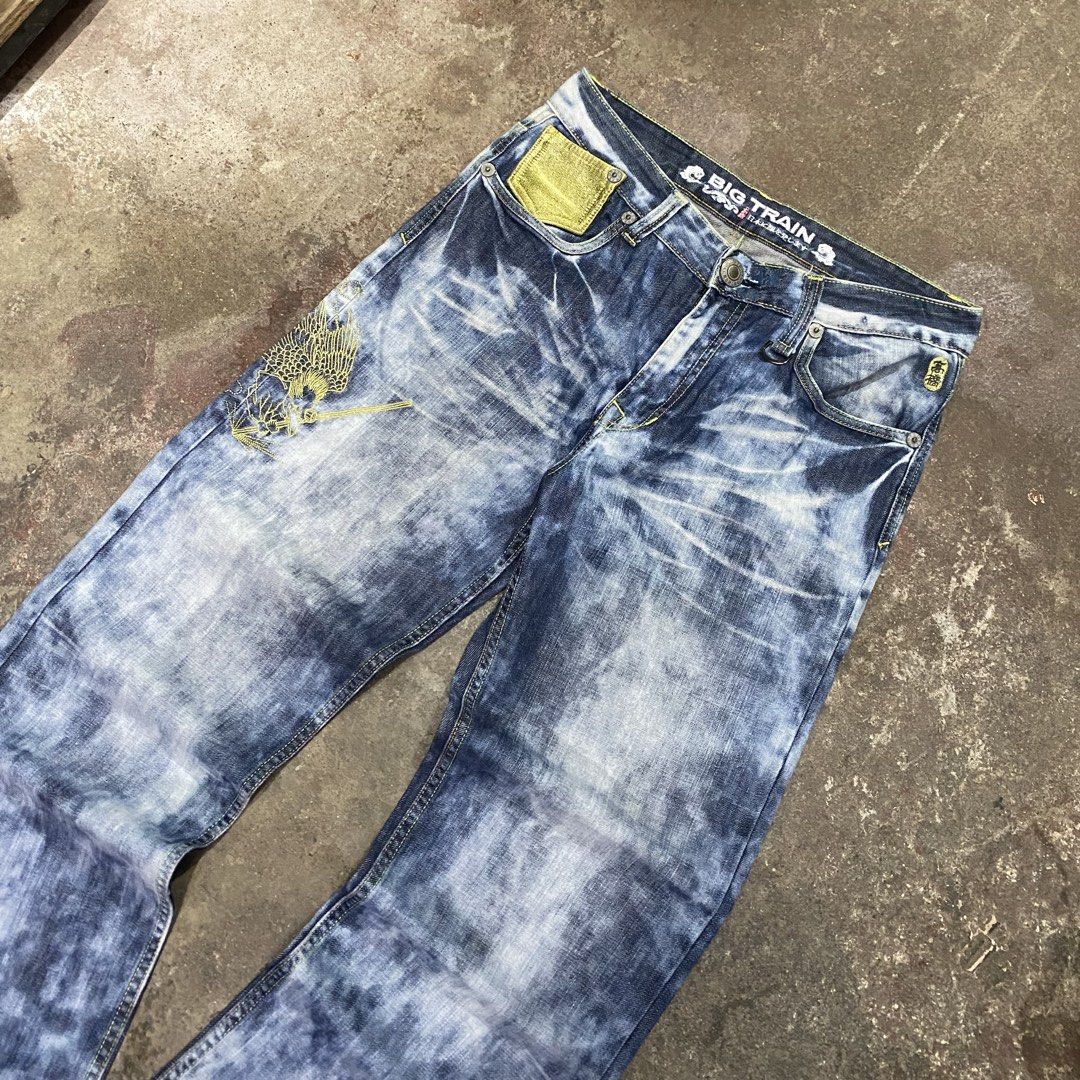Big Train Acid Wash Embroidered Jeans (Category: Jeans) located in Quezon City. Submitted by mgc_thriftshop (Listing ID 1465320991, Image 2). Description: - Brand: Big Train - Wash: Acid wash denim - Fit: Relaxed streetwear fit - Details: Gold embroidery on front and back pockets - Branding: Red leather patch on back waistband - Extras: Front D-ring loop and unique textured pocket detailing waistline 34 Length 39 hem8.