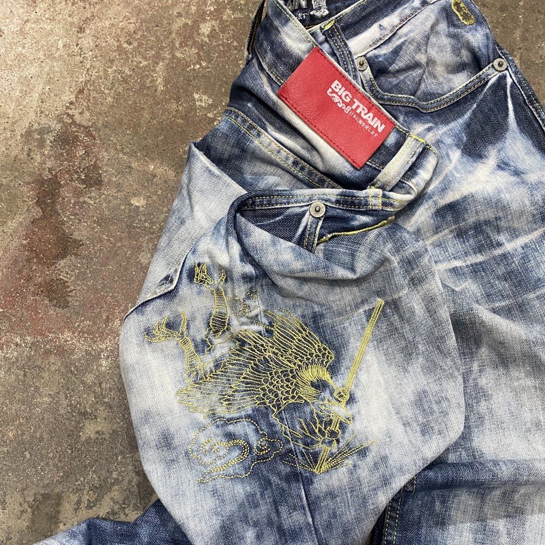 Big Train Acid Wash Embroidered Jeans (Category: Jeans) located in Quezon City. Submitted by mgc_thriftshop (Listing ID 1465320991, Image 3). Description: - Brand: Big Train - Wash: Acid wash denim - Fit: Relaxed streetwear fit - Details: Gold embroidery on front and back pockets - Branding: Red leather patch on back waistband - Extras: Front D-ring loop and unique textured pocket detailing waistline 34 Length 39 hem8.