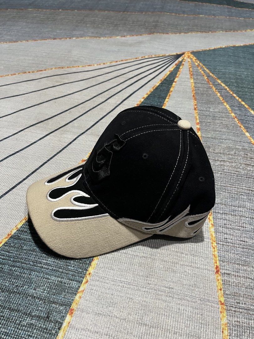Black and Beige Flame Embroidery Baseball Cap (Category: Caps & Hats) located in Puerto Princesa. Submitted by dijaydj28 (Listing ID 1465325206, Image 2). Description: - Color: Black and beige with contrast white stitching - Design: Flame embroidery on brim and sides with front logo - Fit: Adjustable strap closure at the back - Style: Versatile neutral colors, perfect for casual everyday wear.