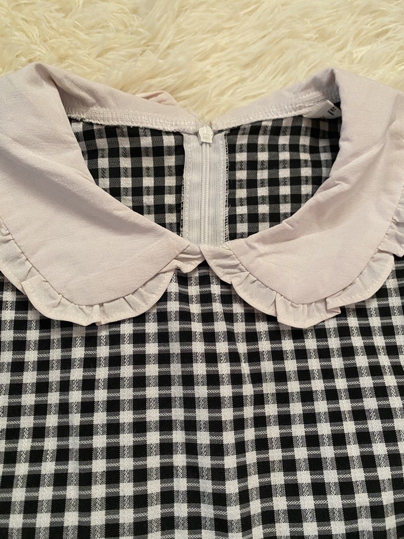 Black and White Gingham Top with Peter Pan Collar (Category: Blouses) located in Guagua. Submitted by zenn_vi (Listing ID 1465272911, Image 2). Description: - Design: Black and white checkered short-sleeve top with a solid light pinkish-grey contrast Peter Pan collar - Details: Rruffled collar edge and exposed back neck zipper closure - Fit & Fabric: Soft, comfortable fabric with a fitted cut and flattering flared hem - Styling: Great casual piec