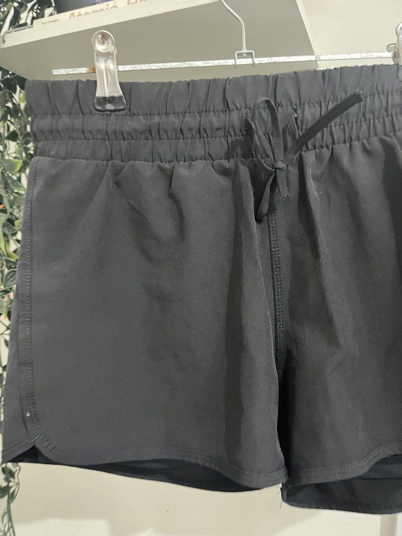 Black athletic running shorts with built-in liner (Category: Shorts) located in Quezon City. Submitted by lemonsandmelons (Listing ID 1465293248, Image 2). Description: - Color: Black - Ideal for workouts, running, or casual errands - Secure fit with an elastic waistband and adjustable drawstring - Flattering curved hem design on the sides - Built-in liner shorts for extra coverage and comfort - Lightweight and breathable fabric.