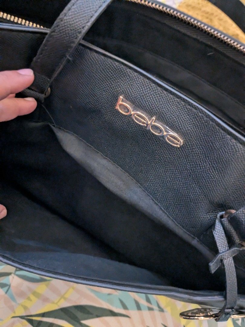 Black Bebe Tote Bag With Gold Hardware (Category: Tote Bags) located in Taguig. Submitted by roxie0419 (Listing ID 1465380346, Image 1). Description: - Brand: bebe - Material: Premium black faux leather with gold-tone hardware and metal logo - Closure: Zip-top closure for added security - Interior: Spacious black fabric lining with 1 zippered pocket and slip pockets - Handles: Sturdy double handles with structured sides - Condition: Clean inside 