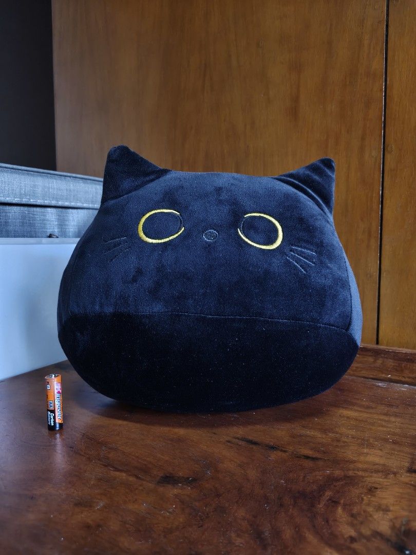 Black Cat Plush Toy Round Pillow (Category: Plushies & Soft Toys) located in Rizal. Submitted by kencamara (Listing ID 1465252970, Image 1). Description: - Item: Round black cat plush toy - Features: Embroidered yellow eyes and whiskers, fluffy stuffing, nice chunky shape - Size: Roughly 10 times the height of an AA battery - Condition: Clean, no stains or damage, like new - Status: Ready for a new home.