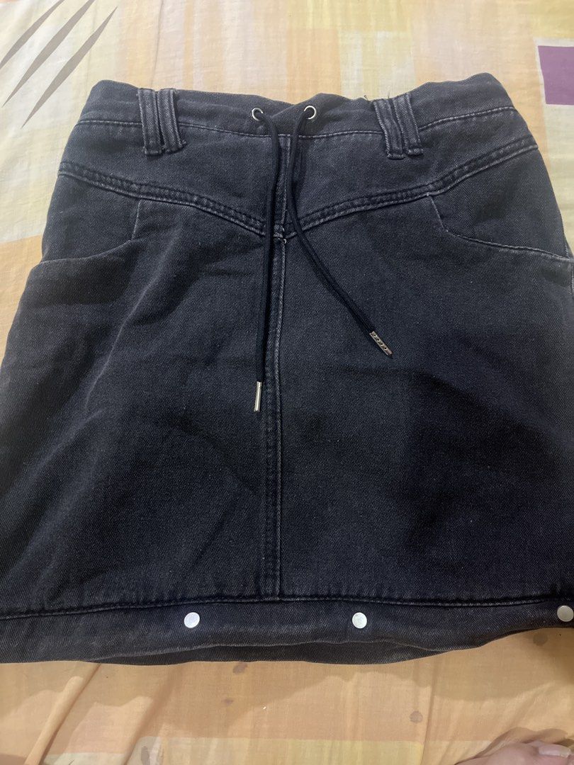 Black Denim Skirt with Drawstring and Front Pockets (Category: Skirts) located in Manila. Submitted by pikbit_10231214 (Listing ID 1465323912, Image 1). Description: - Mini Skirt (Size 29-30 waist and hips) - Color/Finish: Black washed denim - Waistband: Adjustable drawstring with silver metal tips + elastic back for comfort - Pockets: Two deep functional front pockets - Details: Decorative bottom hem buttons and belt loops - Style: Easy to pair 