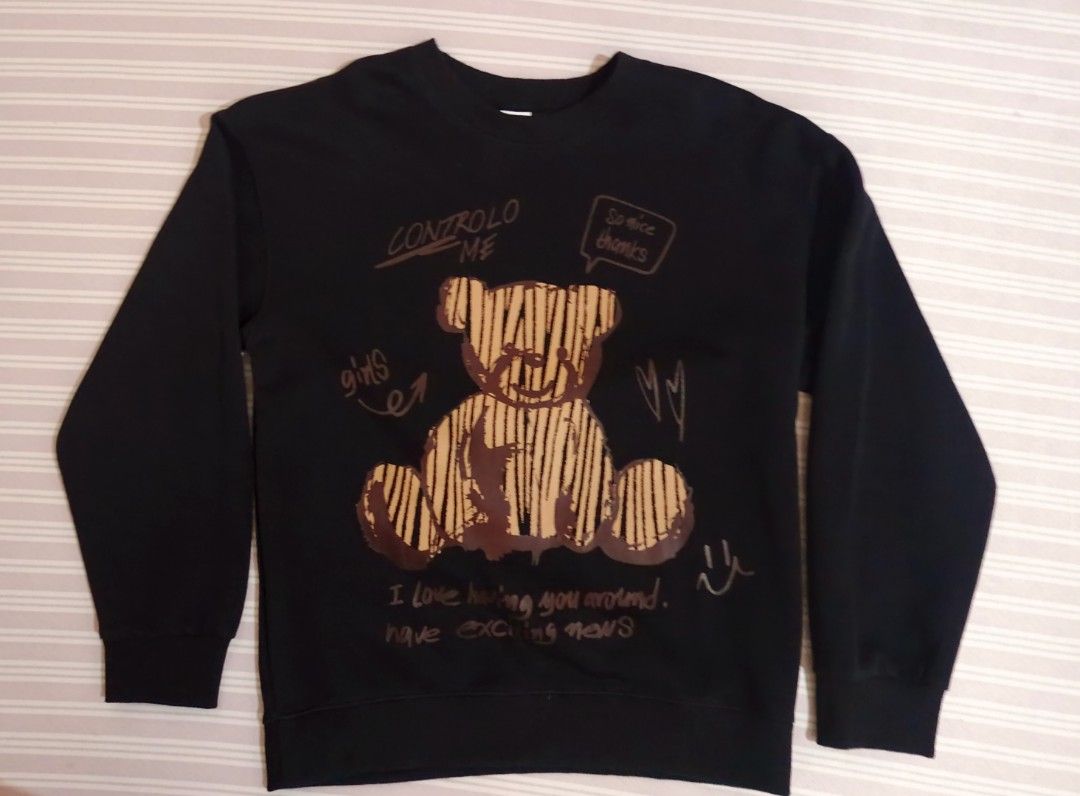 Black Graphic Bear Sweatshirt Size M (Category: Coats, Jackets and Outerwear) located in Manila. Submitted by reysfindsph (Listing ID 1465196789, Image 1). Description: - Style: Casual black sweatshirt with cute teddy bear graphics - Details: Features "CONTROLO ME" and "I love having you around" text on front and back - Size: Medium (170/88A) - Material: Comfortable 100% cotton - Features: Long sleeves, ribbed cuffs, and hem - Condition: Brand ne
