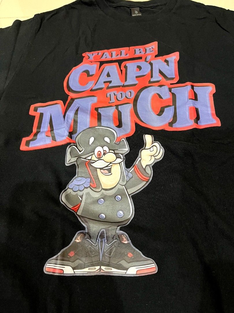 Black Graphic Tee Y'all Be Cap'n Too Much (Category: Activewear) located in Caloocan City. Submitted by bmcfly (Listing ID 1465231221, Image 2). Description: - Color: Black - Small to medium - Fit: Regular fit, standard crew neck - Brand/Tag: Gildan - Design: Large front graphic featuring a cartoon pirate and bold blue and red text 'Y'ALL BE CAP'N TOO MUCH' - Condition: Excellent pre-loved condition, ready to wear.