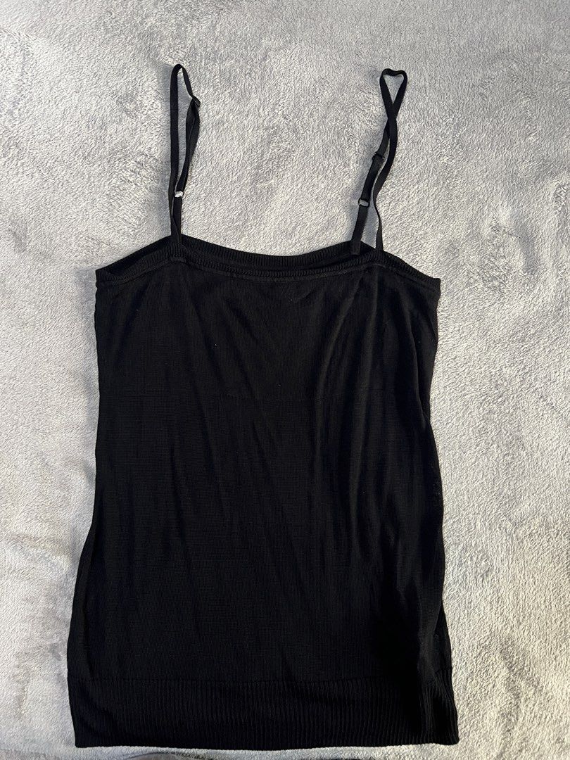 Black knit camisole top with adjustable spaghetti straps (Category: Sleeveless) located in Quezon City. Submitted by prelovededit (Listing ID 1465248180, Image 1). Description: - Color: Classic Black - Material: Soft, stretchy ribbed knit fabric - Design: Square neckline with thin adjustable straps - Fit: Fitted silhouette with a stylish ribbed hem - Styling: Great for layering or everyday wear - Condition: Like new / Excellent quality.