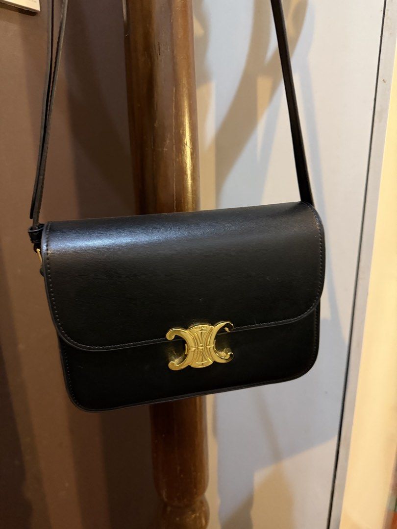 Black Leather Crossbody Bag (Category: Clutches) located in Muntinlupa City. Submitted by everythingmustgo_8475da (Listing ID 1465275879, Image 2). Description: - Style: Crossbody bag - Color/Material: Black smooth leather with contrast white stitching - Hardware: Gold-tone Triomphe closure and adjustable strap buckle - Capacity: Fits phone, keys, and cards easily - Versatility: Perfect for casual daily wear or evening outings.
