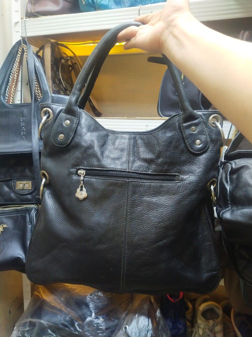 Black leather shoulder handbag (Category: Shoulder Bags) located in Manila. Submitted by dei03_diz (Listing ID 1465233054, Image 2). Description: - Material: Premium black pebble grain leather with silver-tone hardware - Handles: Dual top handles for easy carrying - Exterior: Convenient back zipper pocket - Interior: Spacious main compartment with repeated lettering pattern lining, slip pockets, and a secure zippered pocket - Condition: Excellent