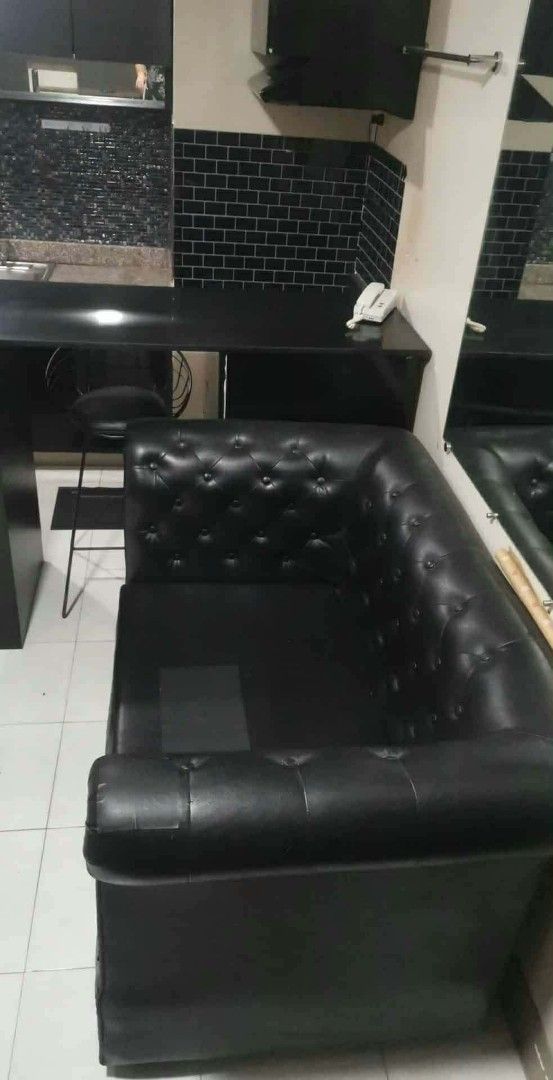 Black Leatherette Sofa (Category: Sofas) located in Manila. Submitted by delcastilloyel (Listing ID 1465177839, Image 1). Description: - Style: Customized Classic Chesterfield sectional sofa - Material: Premium black faux leather with clean, tear-free surface - Design: Elegant deep button tufting on the backrest and armrest - Build: Sturdy construction built to last - Ideal For: Living rooms, condos, or studio apartments - Condition: Well-maintai